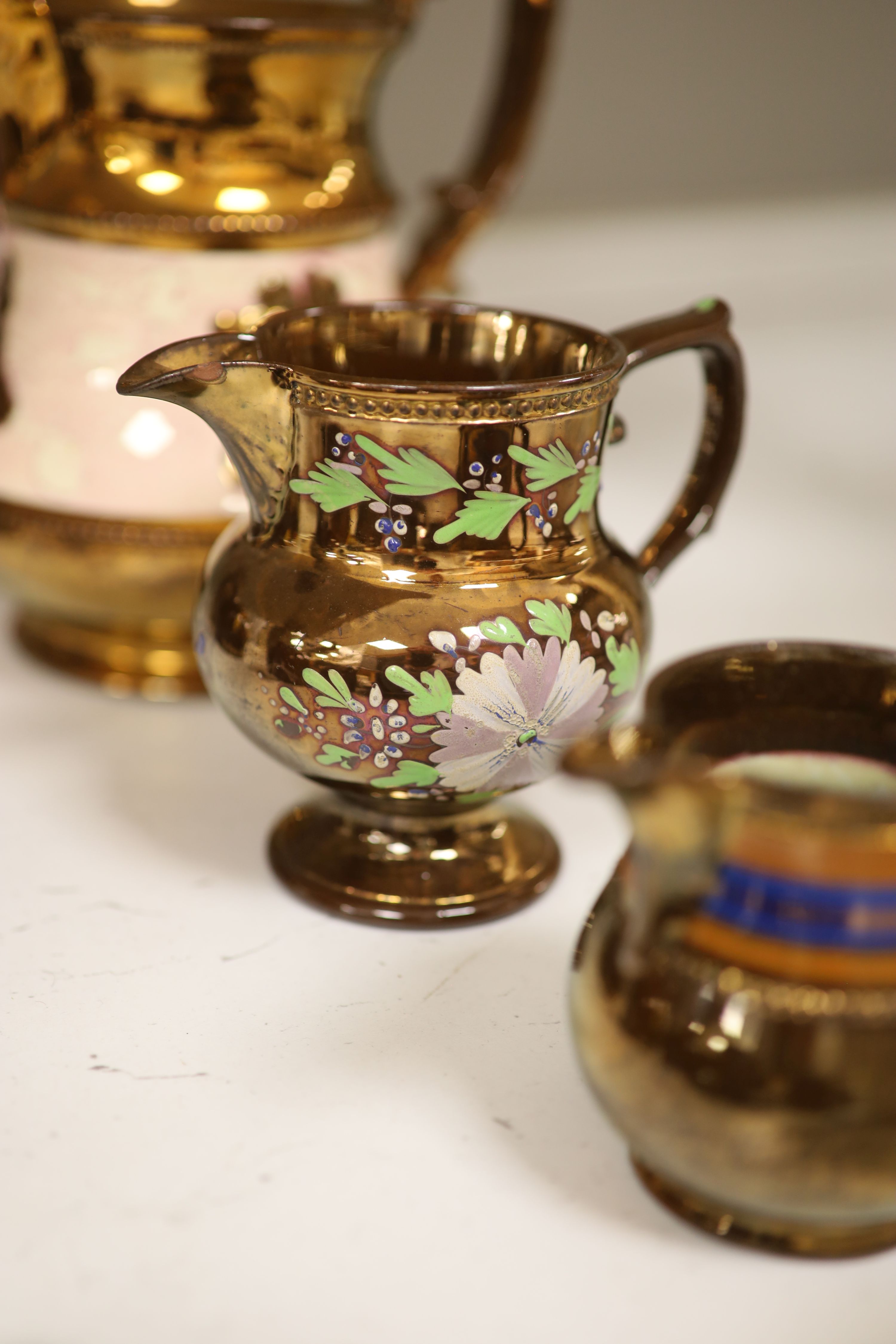 A Royal Doulton silver mounted Hearts Content tea service, and a Doulton Japanese inspired silver mounted jug, assorted lustre jugs